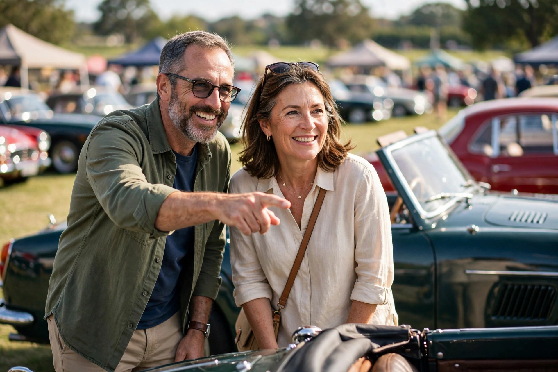 Mature couple admiring classic cars at an outdoor car show