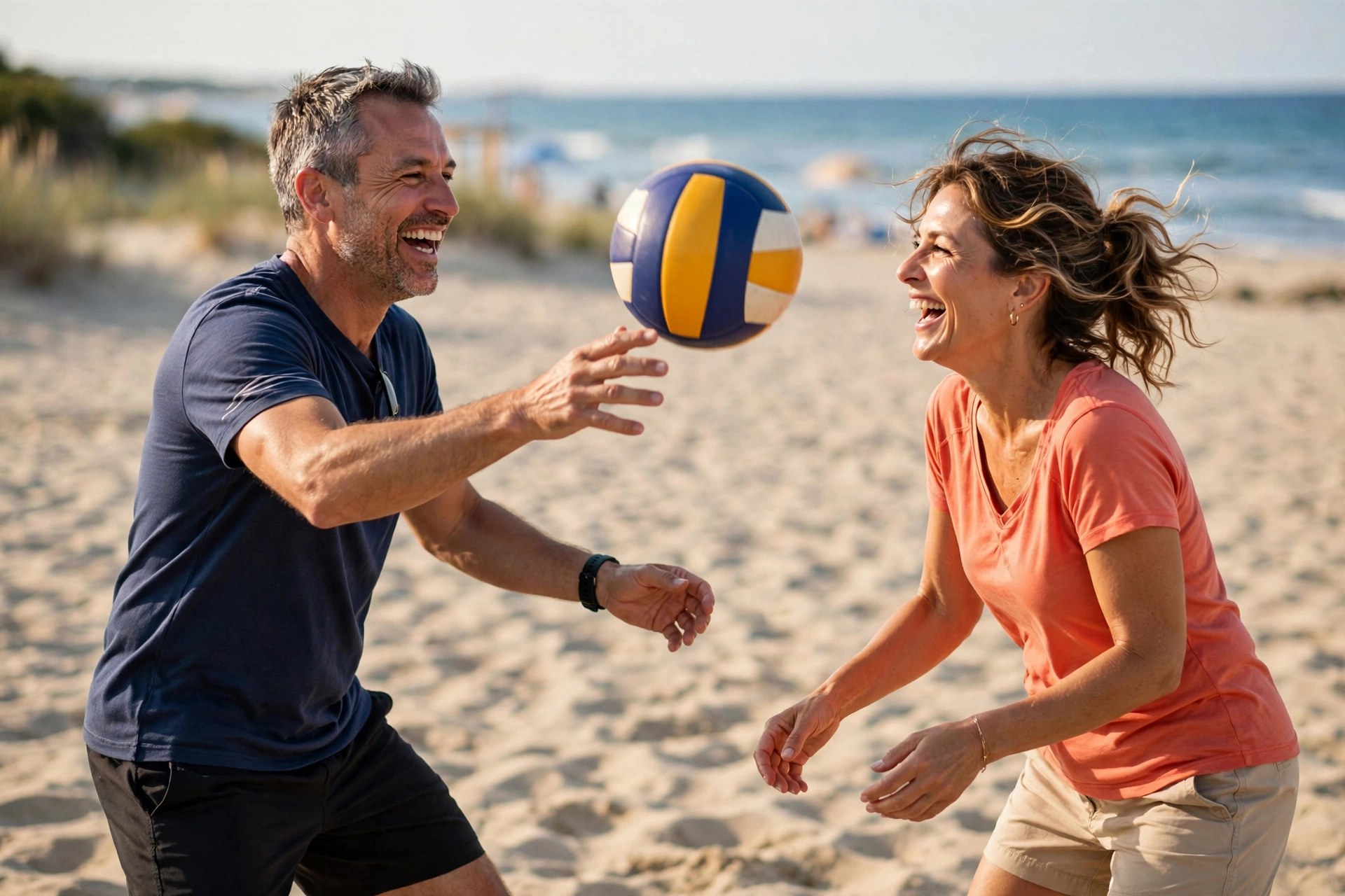 Mature couple playing casual beach volleyball