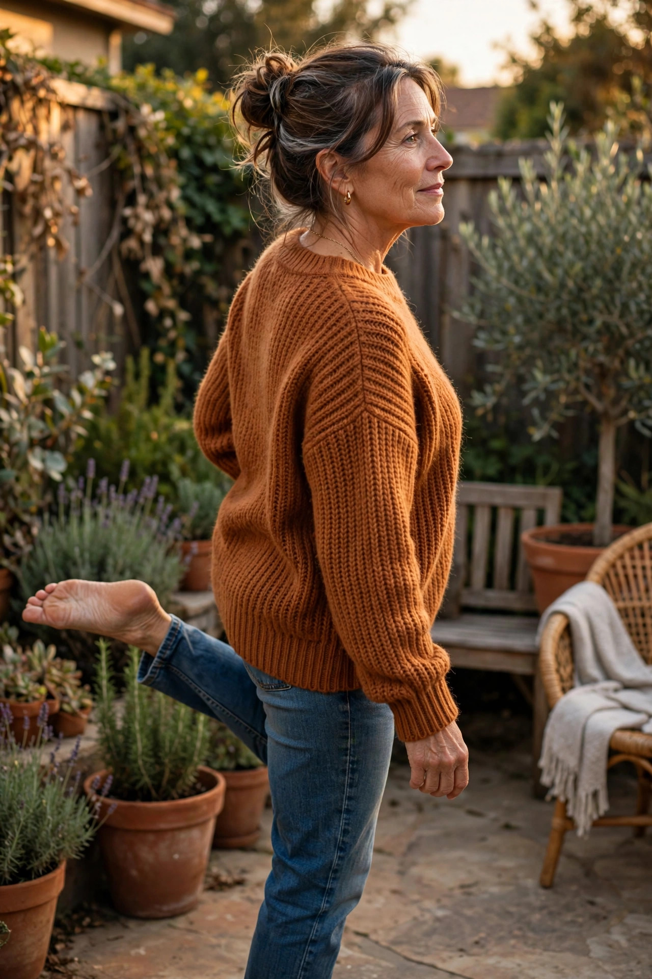 Woman in her 50s standing on one leg turning head
