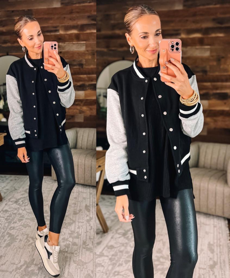 Navy bomber jacket styled with a grey hoodie and black leggings on a woman over 50