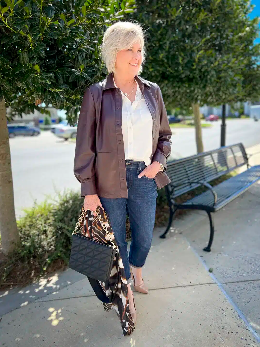 Velvet bomber jacket with cream silk blouse and dark jeans
