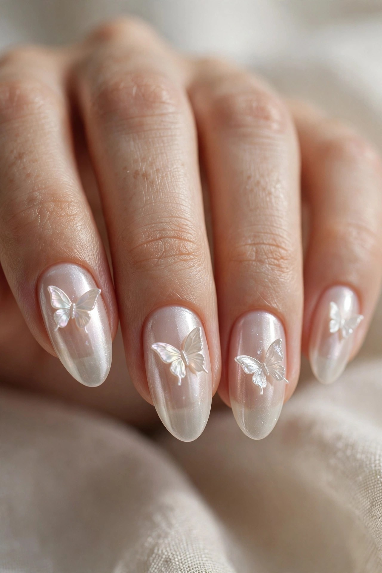 Sheer pearl nails with iridescent pearl butterflies