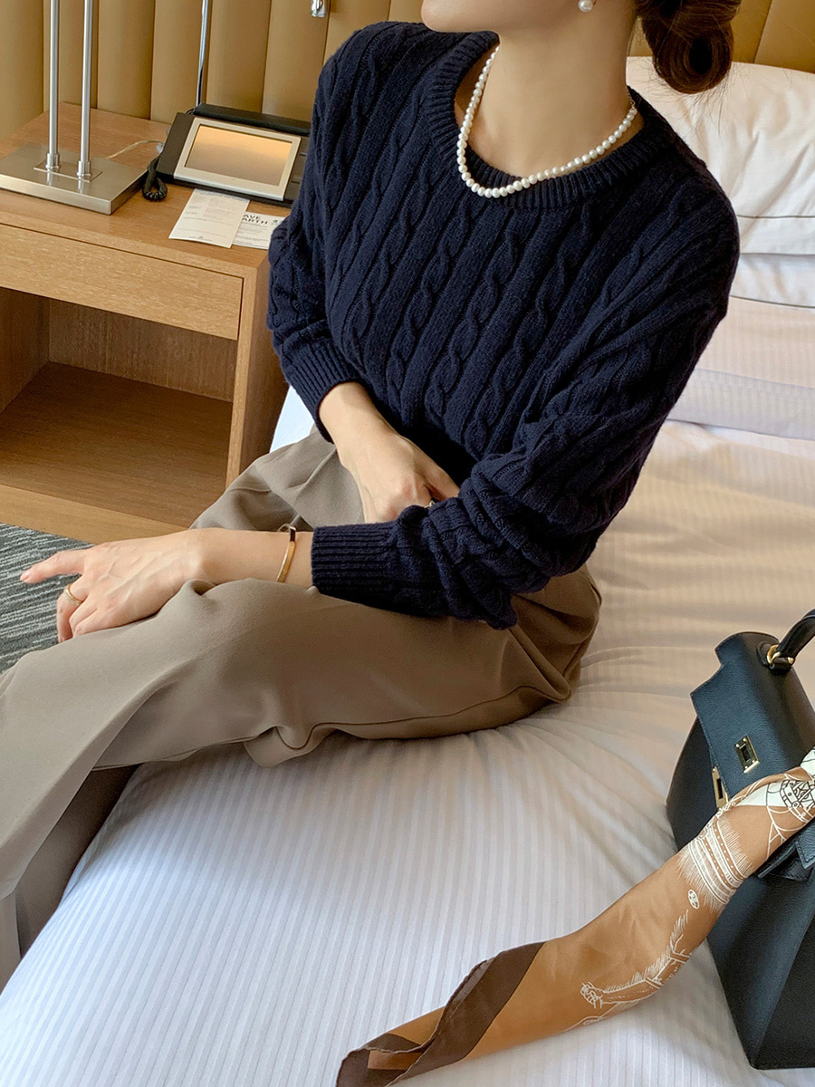 Navy cable knit sweater with silk scarf and wide leg trousers