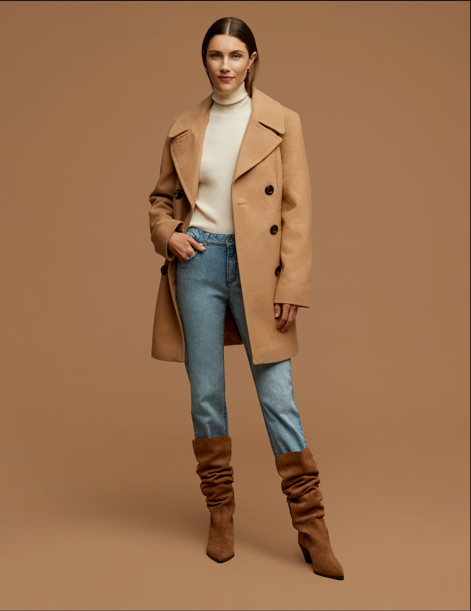 Woman over 50 wearing camel quilted jacket, Fair Isle sweater and riding boots