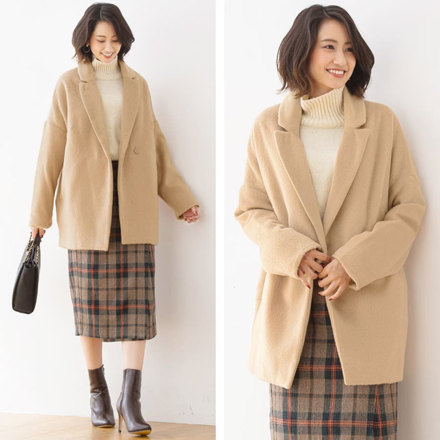 Woman over 50 in camel quilted jacket, turtleneck and plaid midi skirt