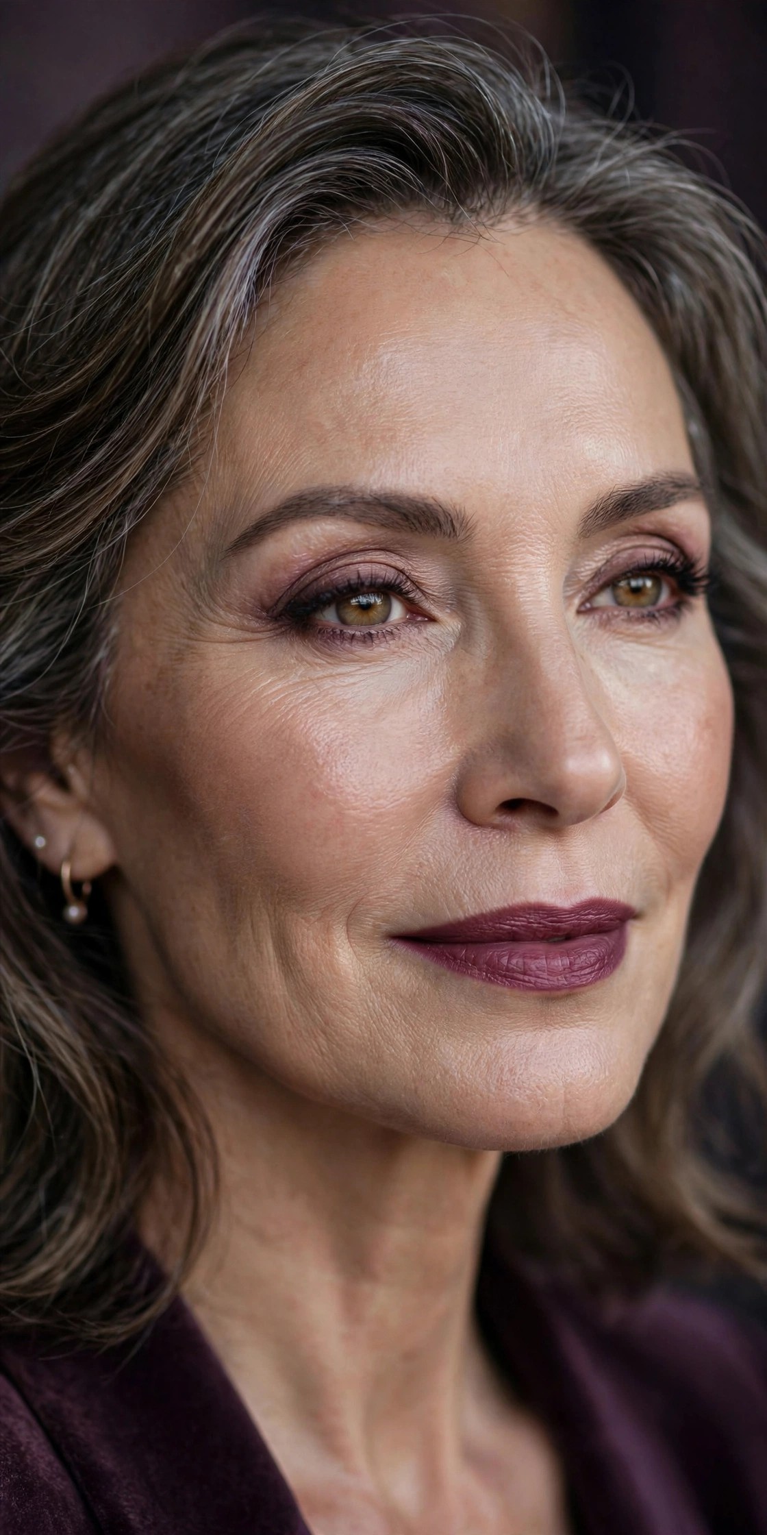 Woman over 50 wearing muted plum lipstick, sophisticated evening makeup