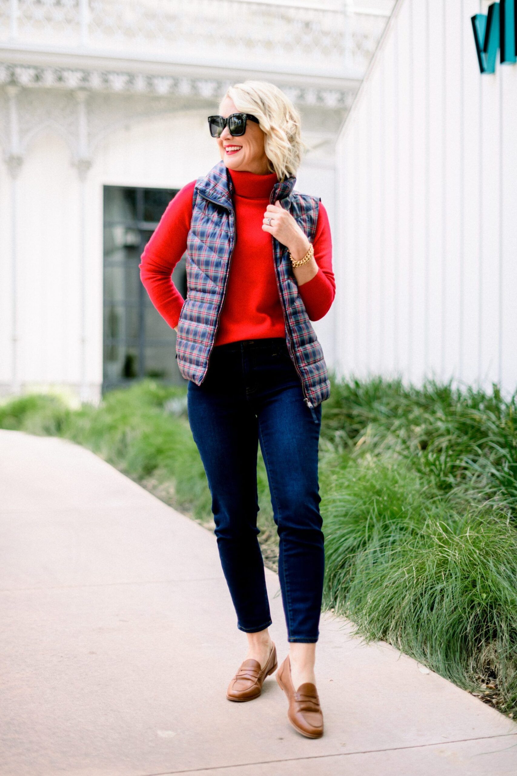 Red sweater with puffer vest and knit beanie for fall sideline outfit woman over 50