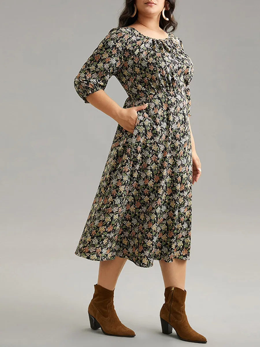 Plus size woman over 60 wearing floral wrap dress with ankle boots