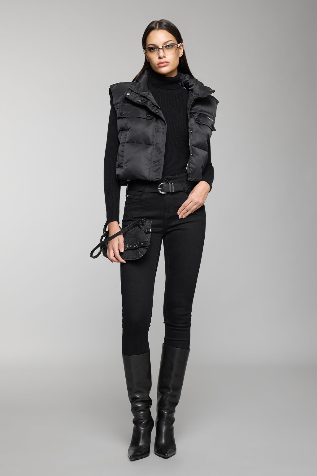 Houndstooth puffer vest with black turtleneck, black jeans and black ankle boots