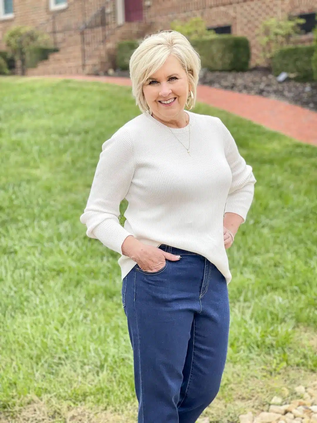 Suede belt with cream sweater and dark jeans fall outfit woman over 50