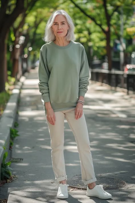 Woman over 50 in a sweatshirt and white sneakers casual fall outfit