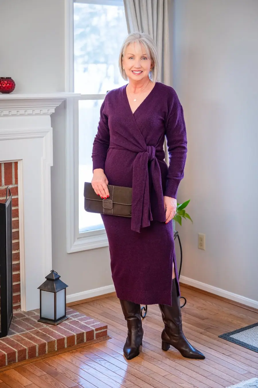 Woman over 50 wearing an elegant wrap dress with knee-high boots