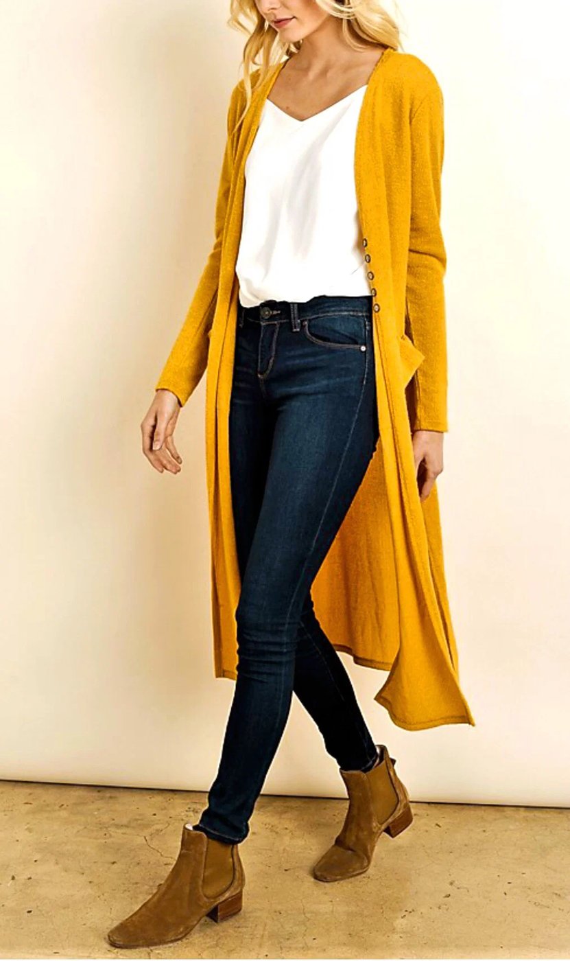 Woman over 50 wearing a mustard yellow cardigan with dark jeans for fall errands