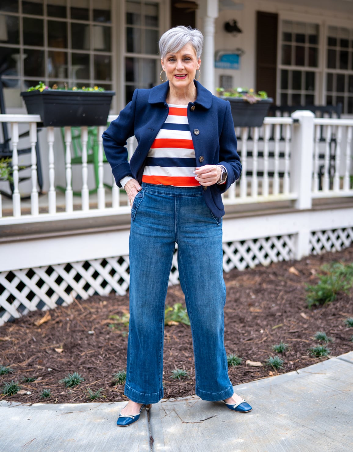 October outfit idea 11: navy blazer striped tee cream jeans on a woman over 50
