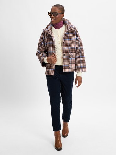 October outfit idea 16: quilted jacket cream cable knit corduroy trousers on a woman over 50
