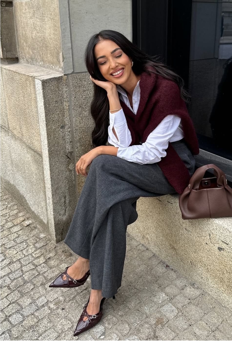 October outfit idea 8: burgundy sweater grey trousers pointed flats on a woman over 50