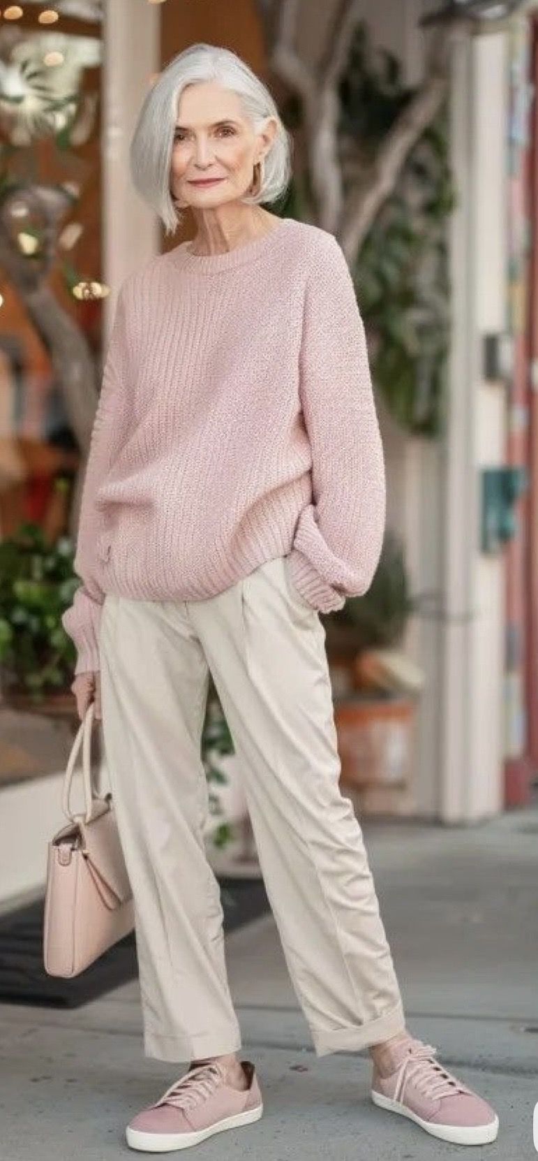 Olive crewneck sweater with dusty pink trousers and cream sneakers, fresh fall outfit