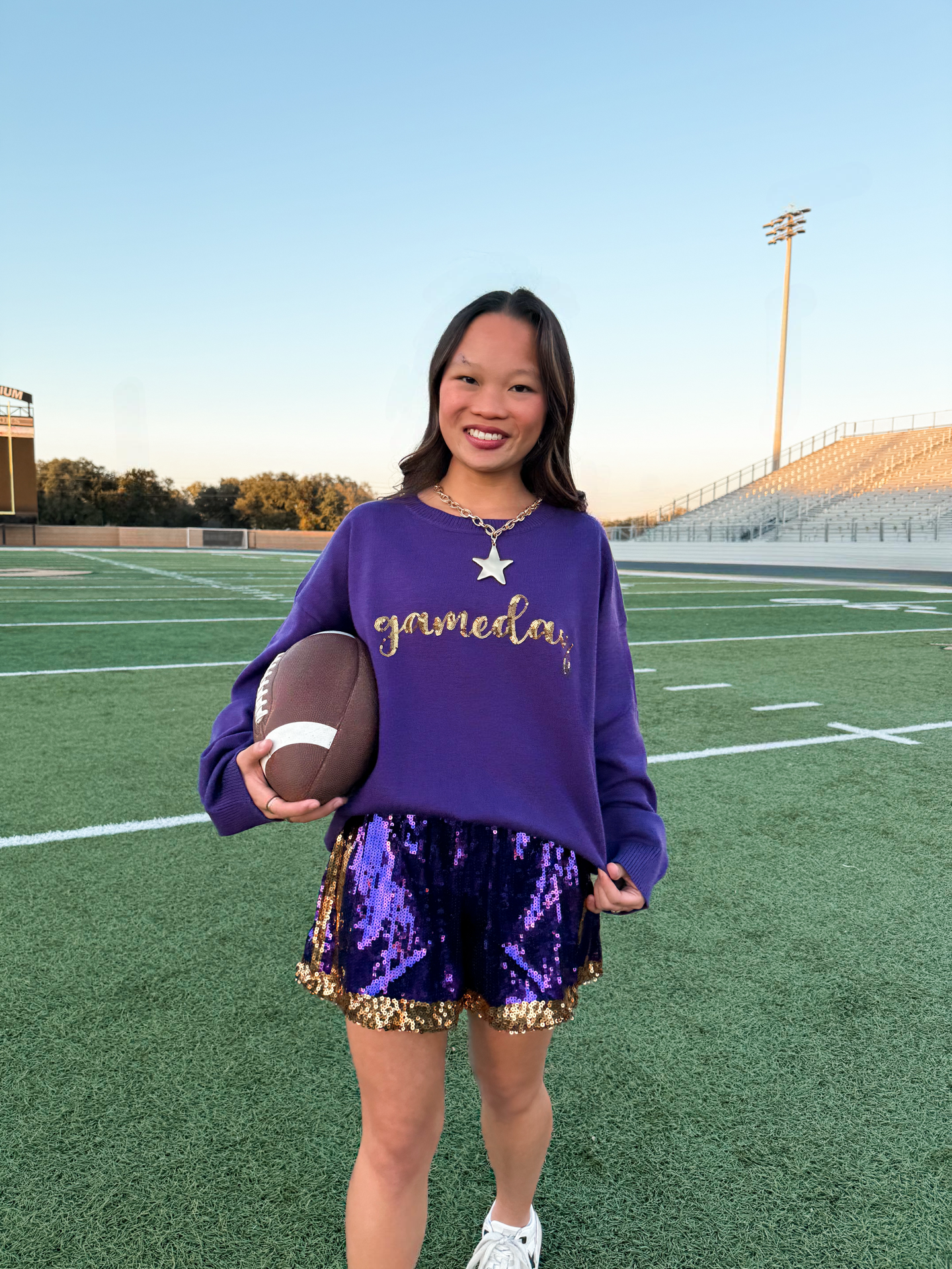 Night Game: Black Coat + Purple Sweater + Gold Accessories - outfit idea for women over 50