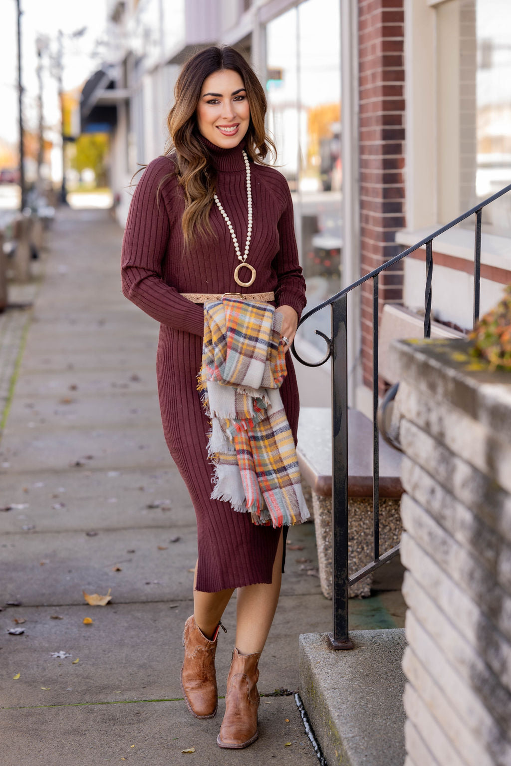 Burgundy sweater dress with tall boots and plaid scarf, fall outfit for women over 50