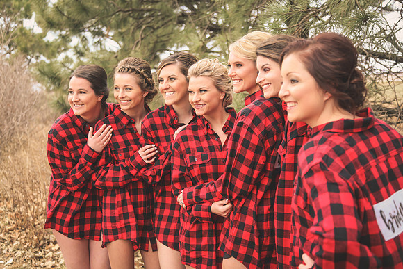 Friends in plaid and solid fall outfits posing together at the pumpkin patch