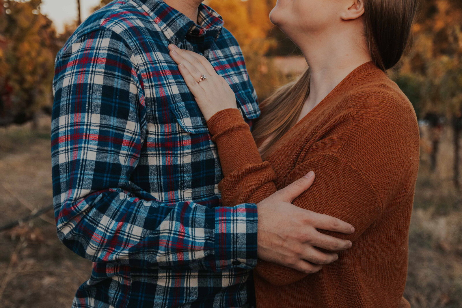 Rust plaid dress and cream sweater couple fall photo outfits at golden hour