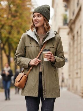 Rust beanie with olive utility jacket and black jeans fall look