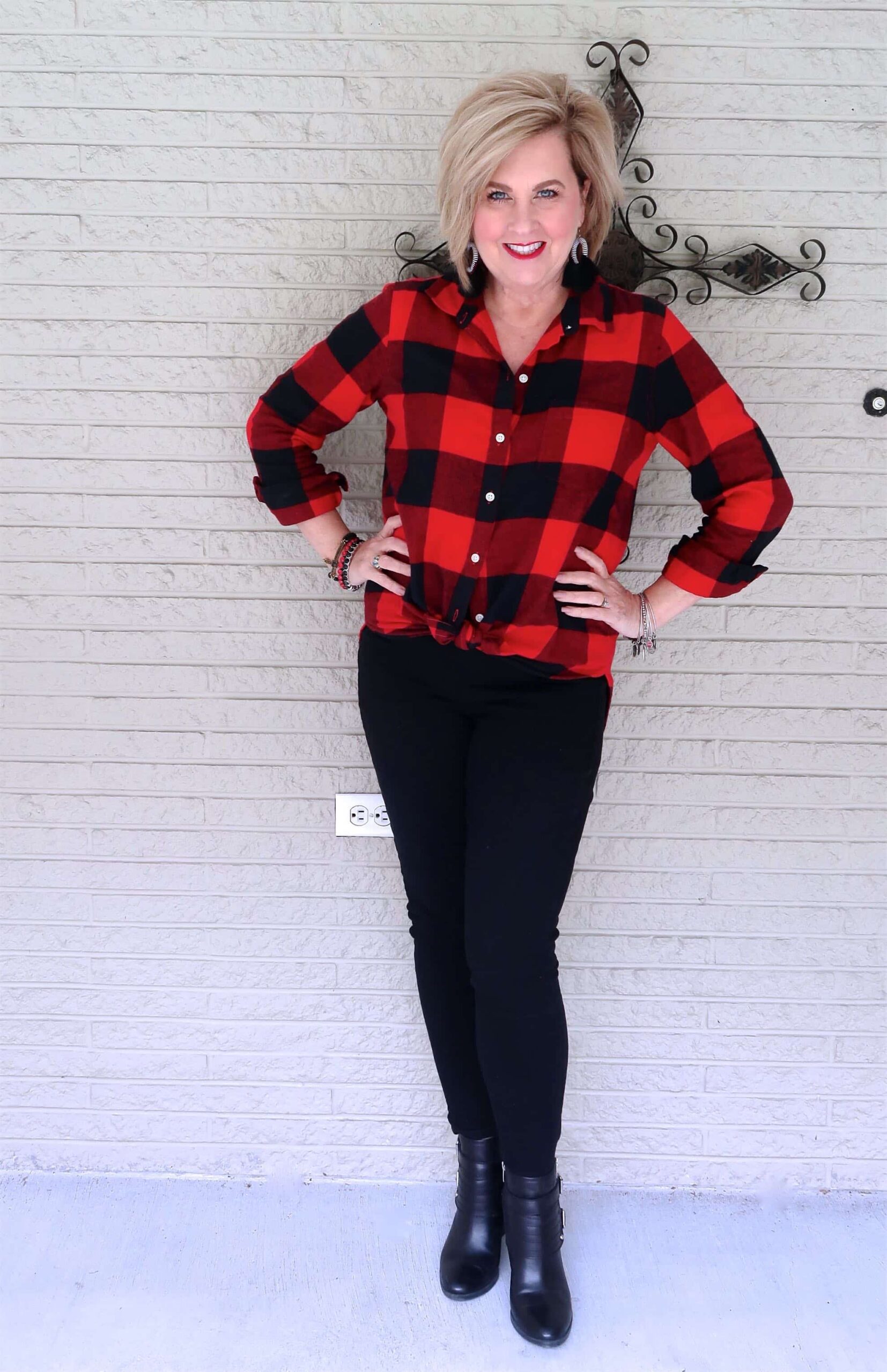 Plaid shacket tied around the waist with a black tee and jeans, woman over 50