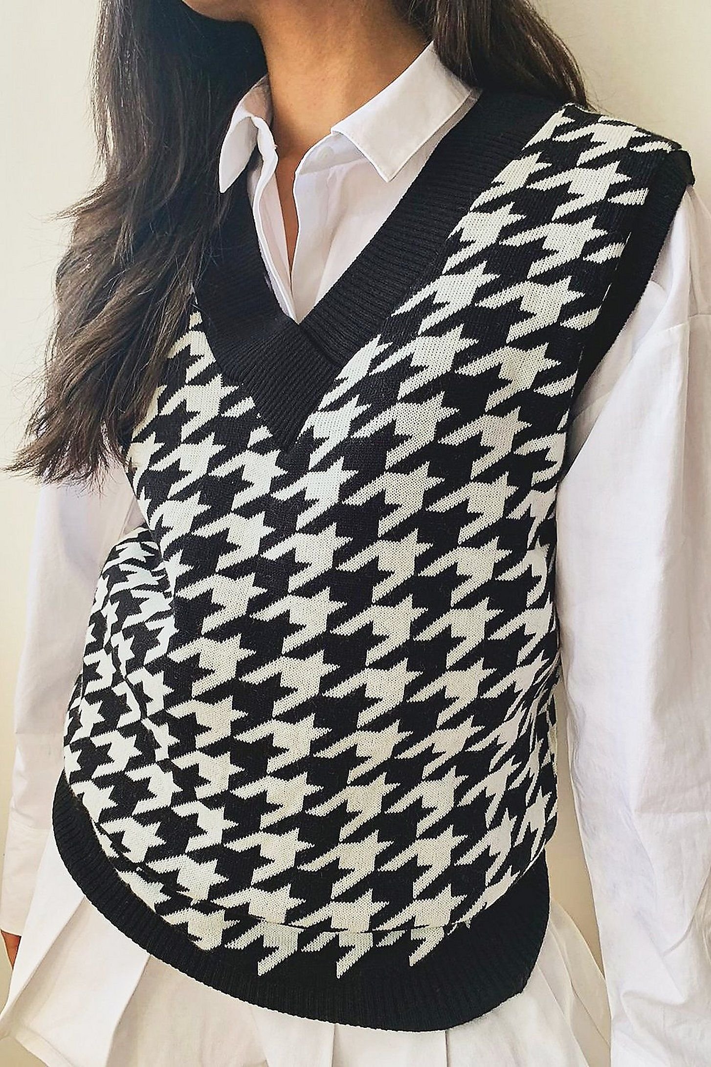 Black sweater vest over white shirt with black wide leg trousers monochrome outfit